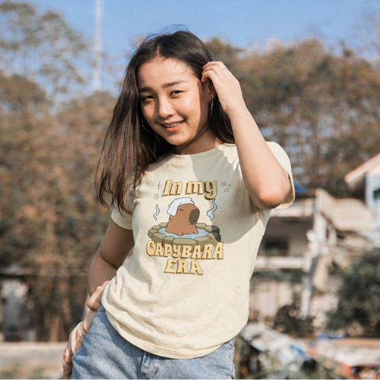 Woman wearing a t-shirt with text and graphics outdoors